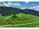 Expansive acreage featuring gently rolling hills, lush green pastures, scattered trees, and the serenity of country living at 15533 S Perry Park Rd, Palmer Lake, CO 80133