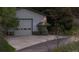 Outside view of the detached barn with large door, windows and concrete driveway at 15533 S Perry Park Rd, Palmer Lake, CO 80133
