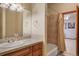 A full bathroom is displayed with a tub, shower, and large vanity and sink at 15533 S Perry Park Rd, Palmer Lake, CO 80133