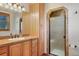 Bathroom featuring vanity, cabinets, and tiled shower at 15533 S Perry Park Rd, Palmer Lake, CO 80133