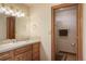 Bright bathroom with tiled vanity, large mirror, and open access to the shower at 15533 S Perry Park Rd, Palmer Lake, CO 80133