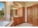 Bright bathroom featuring a tub, decorative statue, and beautiful views from the large window at 15533 S Perry Park Rd, Palmer Lake, CO 80133