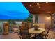 Enjoy the panoramic view from this covered deck with a full dining set and flowers at 15533 S Perry Park Rd, Palmer Lake, CO 80133
