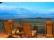 Inviting deck with comfortable seating and breathtaking mountain views creating a serene outdoor living space at 15533 S Perry Park Rd, Palmer Lake, CO 80133