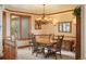 Formal dining room with wood table, chairs, chandelier, and decorative trim at 15533 S Perry Park Rd, Palmer Lake, CO 80133