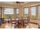 Dining room with scenic views, hardwood floors, and a modern ceiling fan at 15533 S Perry Park Rd, Palmer Lake, CO 80133