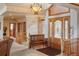 Inviting foyer featuring beautiful hardwood door with glass, bench seating and staircase at 15533 S Perry Park Rd, Palmer Lake, CO 80133