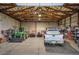 A large garage area with a truck, tractor, and ATV at 15533 S Perry Park Rd, Palmer Lake, CO 80133