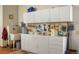 Organized garage featuring ample white cabinetry, a utility sink, and pegboards for tool storage at 15533 S Perry Park Rd, Palmer Lake, CO 80133