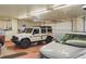 Spacious garage with multiple vehicles parked inside, with tools and storage solutions lining the walls at 15533 S Perry Park Rd, Palmer Lake, CO 80133