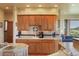 Kitchen featuring wooden cabinets, tile countertops, and an open floor plan at 15533 S Perry Park Rd, Palmer Lake, CO 80133