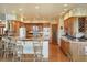 Spacious kitchen with light wood cabinets, breakfast bar, and hardwood floors at 15533 S Perry Park Rd, Palmer Lake, CO 80133