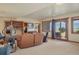 Cozy living room with large windows offering scenic mountain views and a walkout to the backyard at 15533 S Perry Park Rd, Palmer Lake, CO 80133