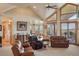 The spacious living room offers large windows, views of the lawn, and plenty of natural light at 15533 S Perry Park Rd, Palmer Lake, CO 80133