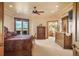 Main bedroom features a balcony with stunning mountain views, tray ceilings, and wooden furniture at 15533 S Perry Park Rd, Palmer Lake, CO 80133