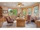 Home office with wood desk, leather chairs, ceiling fan, and natural lighting at 15533 S Perry Park Rd, Palmer Lake, CO 80133