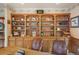 Office area featuring built-in shelving, wood cabinets, and leather office chairs at 15533 S Perry Park Rd, Palmer Lake, CO 80133