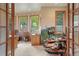 Home office with natural light, wood trim, and a decorative elk statue that adds a touch of the outdoors at 15533 S Perry Park Rd, Palmer Lake, CO 80133