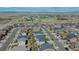 Scenic aerial of a residential area showing symmetrical street layout and adjacent open land under blue, partly cloudy skies at 25062 E Cedar Pl, Aurora, CO 80018