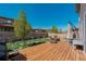 Well-maintained backyard with a wooden deck, manicured lawn, and privacy fence at 25062 E Cedar Pl, Aurora, CO 80018