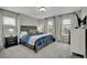 Cozy bedroom with three large windows, plush carpeting, and a dark wooden bed frame at 25062 E Cedar Pl, Aurora, CO 80018