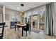 The dining area features a sliding glass door to the back deck, contemporary lighting, and stylish decor at 25062 E Cedar Pl, Aurora, CO 80018