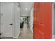 Bright entryway with plank floors, red front door, and an open view of the dining area at 25062 E Cedar Pl, Aurora, CO 80018