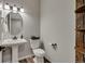 Cozy half bath features pedestal sink, toilet, and charming decor at 25062 E Cedar Pl, Aurora, CO 80018