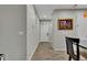 Hallway showcases plank floors, neutral walls, and artwork leading towards an open door at 25062 E Cedar Pl, Aurora, CO 80018