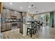 Open concept kitchen with an island, pendant lights, stainless steel appliances, and sliding glass doors at 25062 E Cedar Pl, Aurora, CO 80018