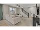 Open living room with a large sectional sofa, ceiling fan, and plenty of natural light at 25062 E Cedar Pl, Aurora, CO 80018