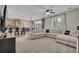 Open-concept living space featuring kitchen, dining area, and large comfortable sectional sofa with contemporary lighting at 25062 E Cedar Pl, Aurora, CO 80018