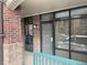 Close-up of the building entrance with glass doors and windows, providing natural light at 3872 S Dallas St # 7-107, Aurora, CO 80014