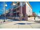 Attractive three-story building with brick accents, balconies, and well-maintained landscaping at 3872 S Dallas St # 7-107, Aurora, CO 80014