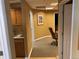 Hallway leading to office spaces, complete with a kitchenette and ample storage cabinets at 3872 S Dallas St # 7-107, Aurora, CO 80014