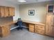 A functional office space with a wrap-around desk, storage cabinets, and overhead lighting at 3872 S Dallas St # 7-107, Aurora, CO 80014
