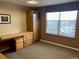 A well-organized office featuring built-in storage, a large window, and neutral decor at 3872 S Dallas St # 7-107, Aurora, CO 80014