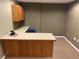 Functional office space featuring a wrap-around desk, overhead cabinet, and carpet flooring at 3872 S Dallas St # 7-107, Aurora, CO 80014