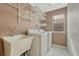 Functional laundry room with white appliances, shelving, and a utility sink for added convenience at 10973 Cannonade Dr, Parker, CO 80138