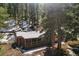 Aerial view of property showcasing cabin surrounded by a dense forest of evergreen trees at 27802 Shadow Mountain Dr, Conifer, CO 80433