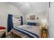 Bedroom featuring a large window with blue curtains and a comfortable bed with decorative pillows at 27802 Shadow Mountain Dr, Conifer, CO 80433