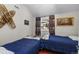 Bright bedroom featuring twin beds, snowshoes on the wall, and rustic decor at 27802 Shadow Mountain Dr, Conifer, CO 80433