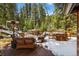 Outdoor deck featuring patio furniture, a heater, and snowy, scenic views at 27802 Shadow Mountain Dr, Conifer, CO 80433