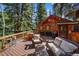 Spacious deck with outdoor seating, dining area, and grill, perfect for relaxing and entertaining at 27802 Shadow Mountain Dr, Conifer, CO 80433