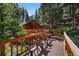 Secluded deck overlooking the creek, with comfortable chairs for enjoying the serene environment at 27802 Shadow Mountain Dr, Conifer, CO 80433