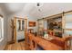 Cozy dining room with vaulted ceilings, hardwood floors, and view of adjoining kitchen at 27802 Shadow Mountain Dr, Conifer, CO 80433