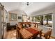 Cozy dining room with vaulted ceilings, chandelier, hardwood floors and view of snow covered forest at 27802 Shadow Mountain Dr, Conifer, CO 80433