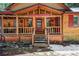 Charming cabin entrance with wooden details and 'Pleasant Memories' sign above at 27802 Shadow Mountain Dr, Conifer, CO 80433