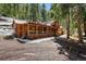 Inviting log cabin with a full-length covered porch, perfect for enjoying the natural surroundings at 27802 Shadow Mountain Dr, Conifer, CO 80433