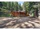 Picturesque log cabin with covered porch and ample parking, nestled in a tranquil wooded setting for serene living at 27802 Shadow Mountain Dr, Conifer, CO 80433